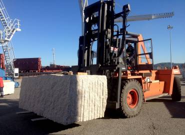 Loading a granite block on a ship